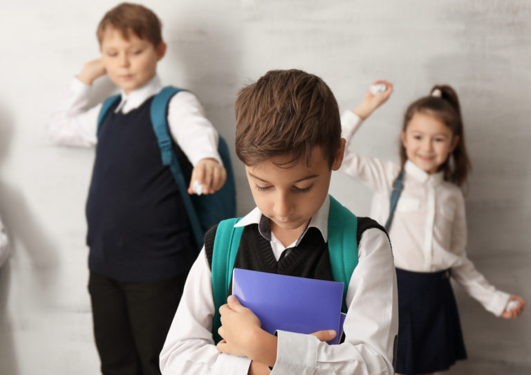 Children bullying their classmate indoors