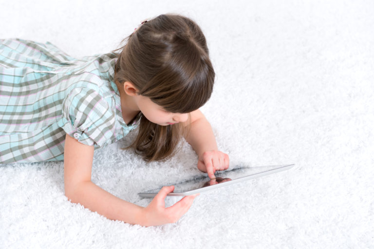 Child playing with digital tablet