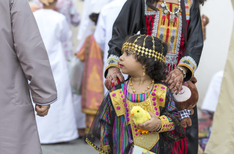 children shopping for toys at a market on a day of Eid